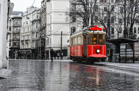 Red nostalgic tram is moving on the Istiklal street in winter da Red nostalgic tram is moving on the Istiklal street in winter da